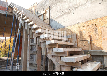 Installation von konkreten Schritten an der Seitenwand beim Bau eines Hauses. Seitenansicht Stockfoto