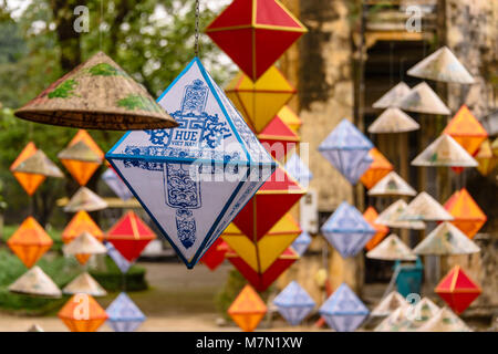 Papierlaternen zum Chinesischen Neuen Jahr hängen mit einem traditionellen Bambus konische Hut in Hoàng thành (Imperial City) ein von Mauern umgebene Zitadelle 1804 in Hue, Vietnam gebaut feiern. Stockfoto