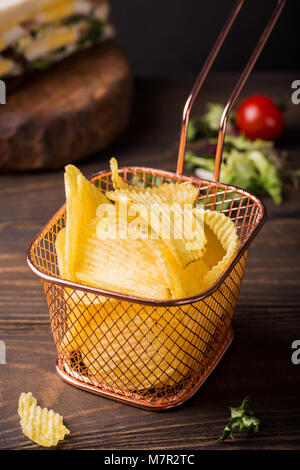 Knusprige Kartoffelchips in Kupfer Warenkorb Stockfoto