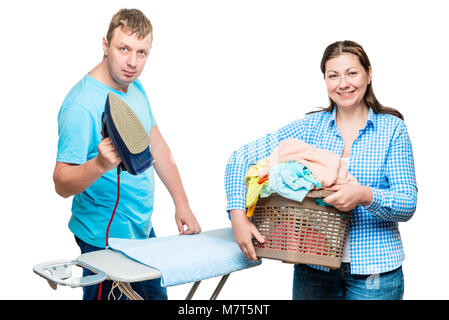 Frau mit Wäschekorb und Mann mit Bügeleisen auf weißem Hintergrund beim Bügeln Stockfoto