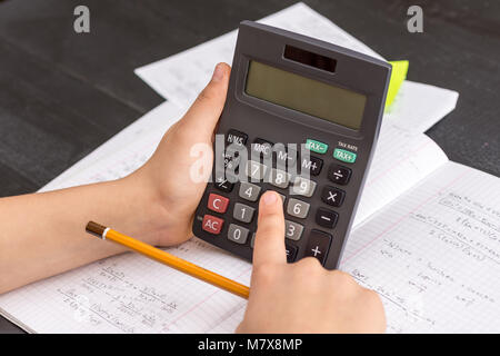 Mit dem Finger auf dem Rechner Taste Während der Mathematischen Lektion. Schule Konzept. Stockfoto