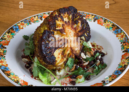 Gegrillten Blumenkohl korma, Koriander und knusprigen Rosinen. Stockfoto