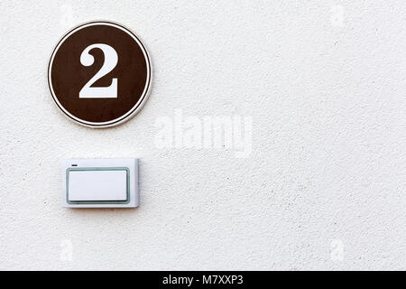 Türklingel und die Platte mit der Nummer zwei wird an einer Wand, Copyspace Stockfoto