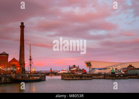 Canning Dock, Liverpool, Merseyside. 14. März 2018. UK Wetter; farbige Sonnenaufgang über der Stadt am Wasser. Am frühen Morgen Sonne funkeln auf dem Windows mit Reflexionen auf dem Wasser. Credit: MediaWorldImages/AlamyLiveNews. Stockfoto