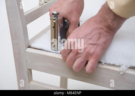 Man polstern einen Stuhl Sitz Stockfoto