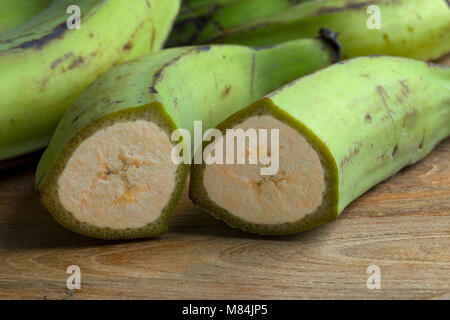 Die Hälfte frische grüne unreife Bananen Stockfoto