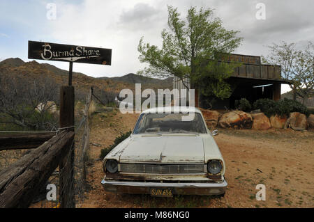 Ein altes Auto und Burma-Shave Werbeschild stand in der Nähe ein verwittertes Holz- Gebäude hinter der Hackberry General Store, eine Route 66 Wahrzeichen in Arizona. Stockfoto