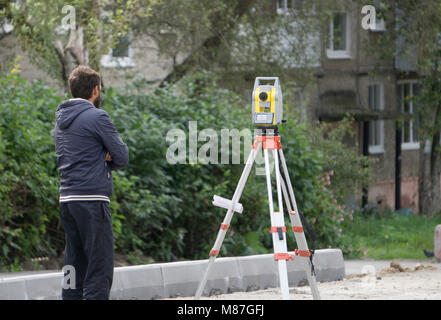 Ein Arbeiter steht neben der Ebene Stockfoto