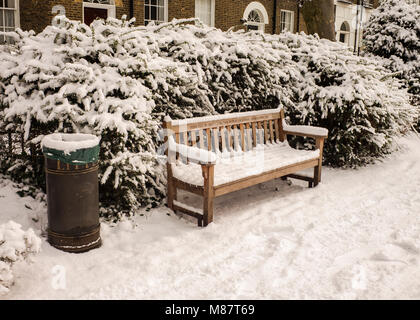 Öffentliche Abfallbehälter und Parkbank viktorianischen Häusern, hinter London Winter mit Schnee bedeckt Stockfoto