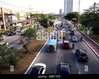 QUEZON CITY, Philippinen - 9. MÄRZ 2018: Fahrzeuge Pass entlang einer in der Regel stark befahren Katipunan Avenue in Quezon City, Philippinen. Stockfoto