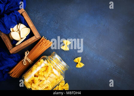 Verschiedene Arten von Pasta, rohe Nudeln auf einem Tisch Stockfoto