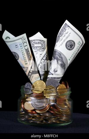 US-Dollar in ein Glas kann mit Münzen gefüllt Stockfoto
