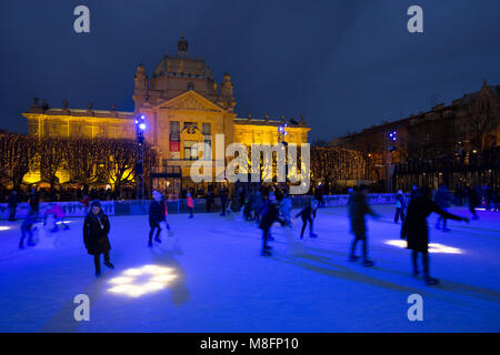 Menschen auf der Eisbahn in der Nacht auf König Tomislav Platz während der Adventszeit in der Stadt Zagreb, Kroatien Stockfoto