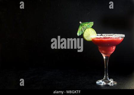 Strawberry Margarita Сocktail mit Kalk auf schwarzen Stein Tabelle, kopieren. Frozen Margarita oder Daiquiry Cocktail. Stockfoto