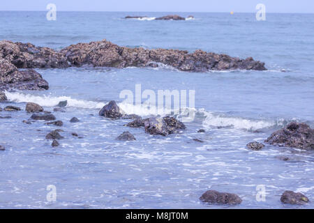 Aiguas Blanques Agua Blanca Ibiza Strand mit türkisblauen Wasser auf dem Sand von einem Meer Strand, soft Wave und solar Blendung. Stockfoto