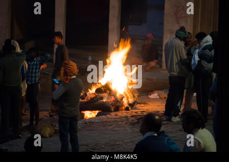 VARANASI, Indien. 28. Februar 2017: Die Menschen auf dem Scheiterhaufen sehen, die Nacht. Die Zeremonie der Einäscherung von Manikarnika Ghat am Ufer des Stockfoto