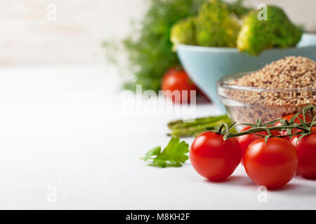Gesunde Ernährung Essen. Quinoa in eine Glasschüssel, Cherry Tomaten, Spargel, Brokkoli auf einen hellen Hintergrund konkrete Stockfoto