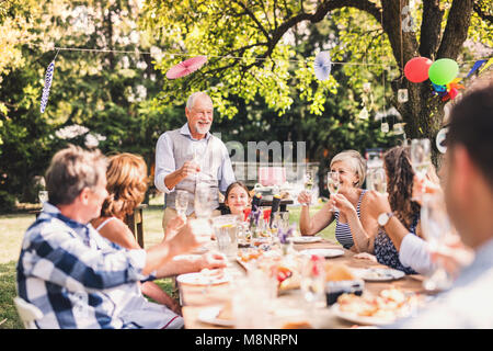 Familienfeier oder eine Gartenparty außerhalb im Hinterhof. Stockfoto