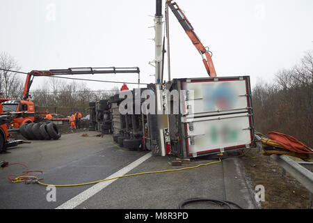 20. März, Deutschland, Boppard: Erholung der Arbeitnehmer versuchen, rechts ein Moloch mit Rindfleisch, die auf der Autobahn 61 (A61) Autobahn in der Nähe von Boppard umgeworfen. Die Autobahn musste mehrere Stunden gesperrt werden. Foto: Thomas Frey/dpa Stockfoto