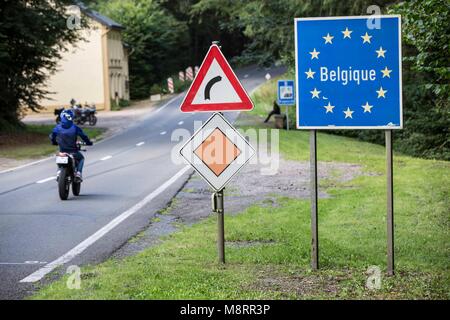 Ein blaues Schild mit dem Perkele Belgique umrandet von goldenen EU-Sternen symboliziert den Grenzübertritt / Belgien in of this Landstraße in Stockfoto