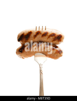 Gegrillte Würstchen auf vintage Gabel isoliert auf weißem Stockfoto