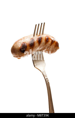 Gegrillte Würstchen auf vintage Gabel isoliert auf weißem Stockfoto