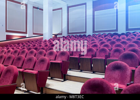 Blick von der Treppe auf Reihen von komfortablen roten Stühle im Theater oder Kino. Kurve der rote Sitze Stockfoto