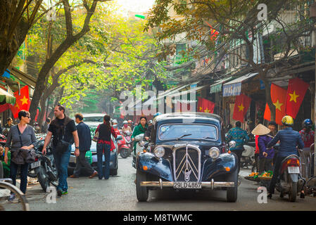 Hanoi Vietnam Old City, Blick auf einen Citroen-Wagen aus der französischen Kolonialzeit, der durch eine enge Straße in der historischen Altstadt von Hanoi, Vietnam, gefahren wird. Stockfoto