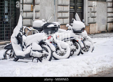 Eine Gruppe von schneebedeckten Roller in einer Stadt. Stockfoto