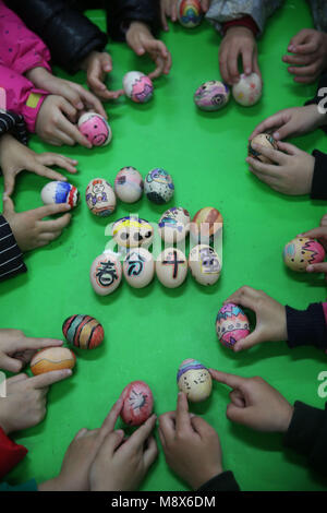 Xiangxi. 21 Mär, 2018. Kinder spielen ein Spiel Eier am Ende zu stehen in einem Kindergarten in Jishou, der Central China Provinz Hunan, März 21, 2018, auch den Tag der 'Chunfen'. Chunfen, was wörtlich bedeutet Frühlingspunkt oder Tagundnachtgleiche, fällt auf den Tag, wenn die Sonne genau auf die himmlischen Breitengrad von Null Grad. Credit: Peng Biao/Xinhua/Alamy leben Nachrichten Stockfoto