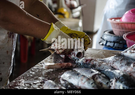 Vorbereiten der Fische, Entfernen der Schuppen von den Fischen, so dass er auf dem Markt verkauft werden kann. Stockfoto