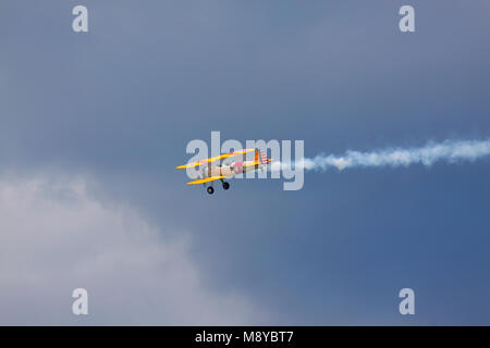 Die Boeing Stearman N2S-3 in der US Navy Abzeichen über dunklen Himmel fliegen während der International Air Show im 90. Jubiläumsjahr der polnischen Luftwaffe Akademie. Stockfoto