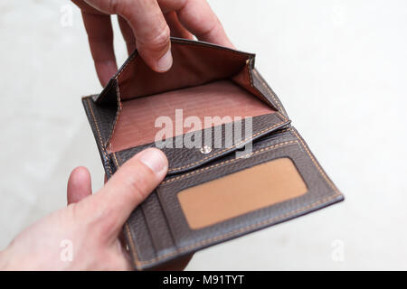 Hände halten eine offene Geldbörse mit kein Geld Stockfoto