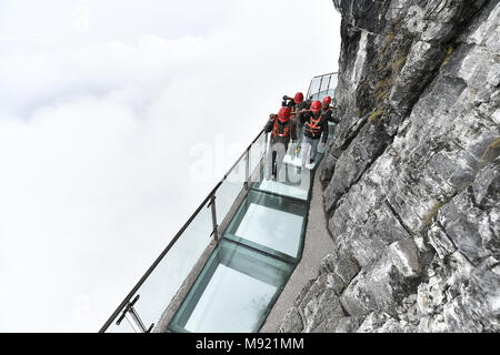 Zhangjiajie, Hunan Provinz Chinas. 21 Mär, 2018. Die Arbeitnehmer tragen Glasplatten für den Austausch der Glas Fahrbahn in Tianmenshan Scenic Area in Granby, der Central China Hunan Provinz, 21. März 2018. Austausch des Glases Bürgersteig auf der Westseite in Tianmenshan ist in Bearbeitung, die voraussichtlich in zwei Tagen abzuschließen. Credit: Shao Ying/Xinhua/Alamy leben Nachrichten Stockfoto