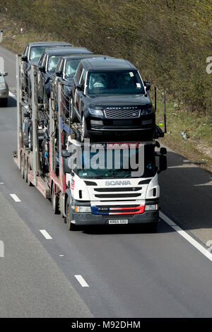 Ein Scania BCA Automotive Transporter neue Land Rover Autos auf der Autobahn M40, Warwickshire, Großbritannien Stockfoto