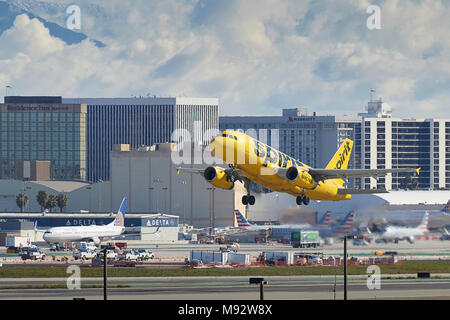 Spirit Airlines Airbus A319 fliegen Sie vom internationalen Flughafen von Los Angeles, LAX, Wolken über die schneebedeckten San Gabriel Berge dahinter. USA Stockfoto