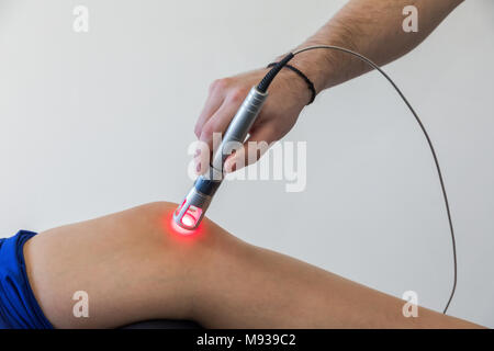 Laser Therapie auf ein Knie, angewendet zur Behandlung von Schmerzen. selektive Fokus Stockfoto