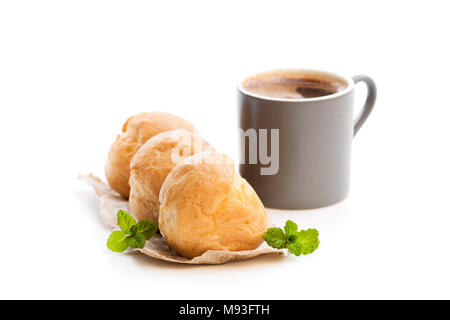 Hausgemachter Windbeutel mit Tasse Kaffee isoliert auf weißem Stockfoto