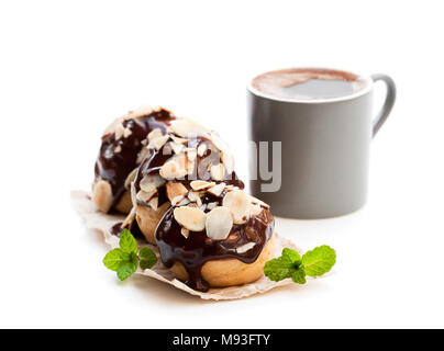 Hausgemachter Windbeutel mit Tasse Kaffee isoliert auf weißem Stockfoto