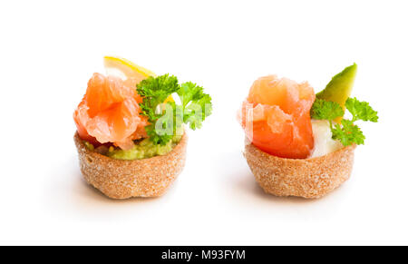 Croustades knuspriges Gebäck Fällen gefüllt mit gesalzenen Lachs und Avocado isoliert auf weißem Stockfoto