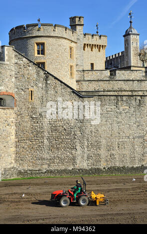 London, England, UK. Tower von London (11.-14 thC) Kleine Traktor pflügen Land in den burggraben (März 2018) Devereux Turm (L) Stockfoto