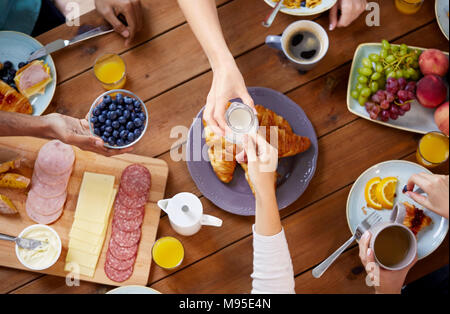 Personen mit Frühstück in der Tabelle mit Nahrungsmitteln Stockfoto