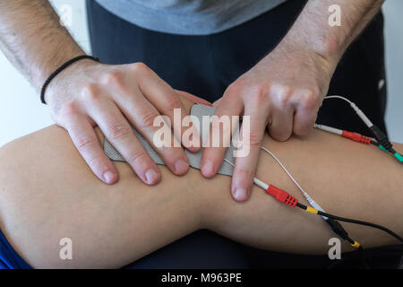 Elektronische Therapie auf Knie angewendet zur Behandlung von Schmerzen. selektive Fokus Stockfoto