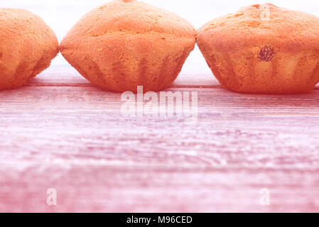 Grenze von frischem Holz Cupcakes auf einem blauen Hintergrund Stockfoto