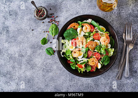 Gesunde Salatteller. Frische Meeresfrüchte Rezept. Gegrillte Garnelen und frisches Gemüse Salat und Ei. Gegrillte Garnelen. Gesundes Essen. Flach. Ansicht von oben Stockfoto