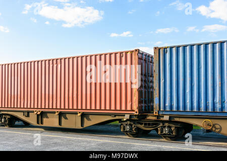 Zwei Container auf einer flachen Auto Zug in einem Hof in der Region Paris, Frankreich geparkt. Stockfoto