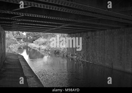 Infared Blick von unter einer Eisenbahnbrücke entlang der Bridgewater und Taunton Canal an Obridge, Taunton, Somerset, UK Stockfoto