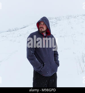 Mann mit leerer Grauer Hoodie, im städtischen Hintergrund in der Nähe des Flusses. Stockfoto