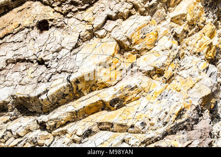 Hintergrund Textur in der Nähe von golden gefärbten zerklüfteten felsigen Abhang mit Gletscherspalten in Santa Barbara, Kalifornien, USA Stockfoto