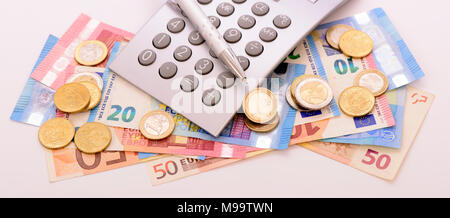 Euro Währung mit Banknoten, Rechner und Münzen Stockfoto